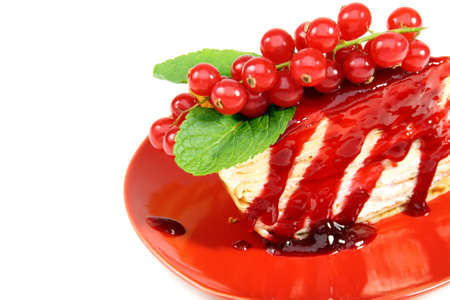 Crepe cake with berry sauce closeup on white background.の写真素材