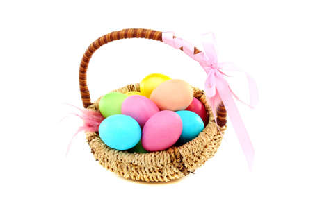 Colorful Easter eggs in basket on a white background.の写真素材