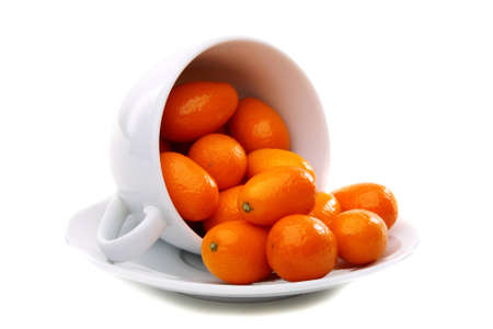 Kumquats in cup on a white background. の写真素材