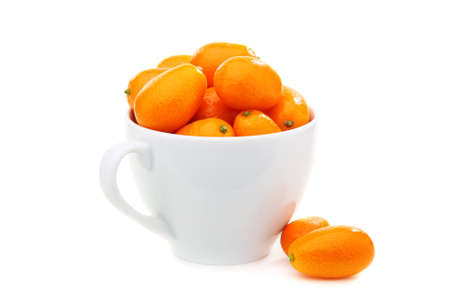 Kumquats in cup on a white background.の写真素材