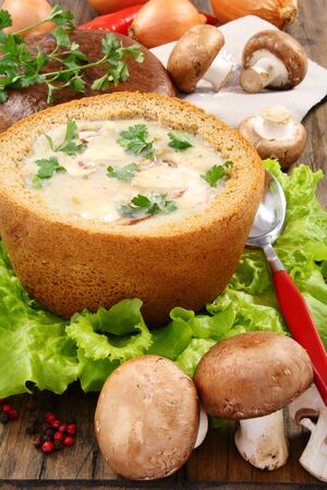 Potato soup with mushrooms in a bread bowl.の写真素材
