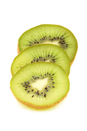 Kiwi fruit is cut into slices on a white background.の写真素材