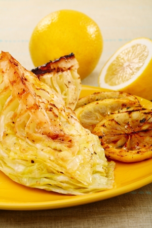 Cabbage with lemon sauce on a yellow plate. の写真素材