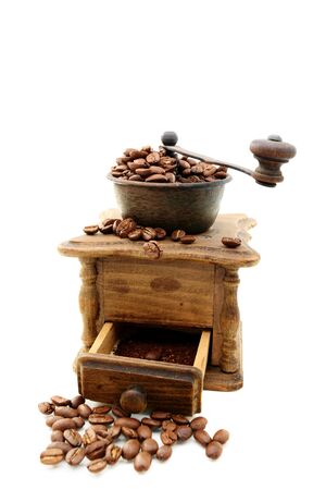 Old mill with coffee beans on a white background の写真素材