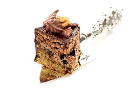 Piece of chocolate cake with prunes on a white background  の写真素材