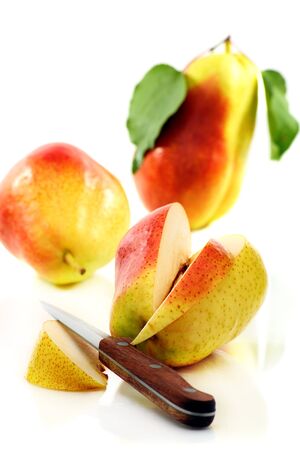 Three ripe pears and knife on a white background  の写真素材
