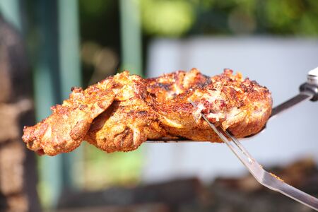 Delicious piece of meat grilled outdoors の写真素材
