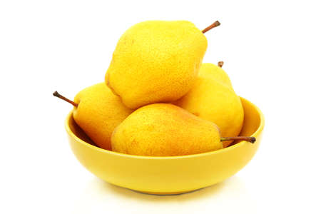 Four ripe pears in yellow bowl on a white background の写真素材