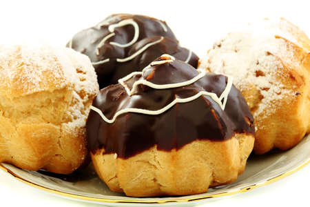Cakes eclairs on a plate closeup  