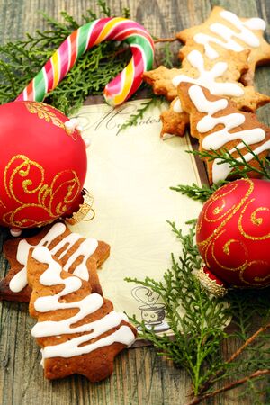 Christmas balls, gingerbread and candy cane on a wooden table  の写真素材