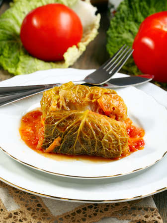 Stuffed cabbage with tomato sauce on a white plate の写真素材