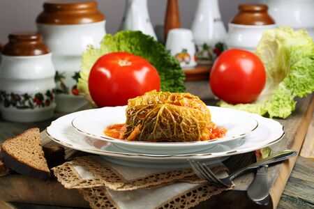 Savoy cabbage stuffed with meat on a white plate の写真素材