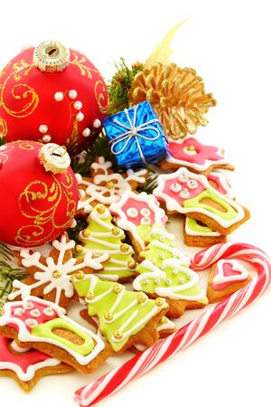 Christmas balls, gingerbread and golden cones on a white background の写真素材