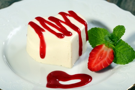 Panna cotta in the shape of a heart with cherry sauce の写真素材