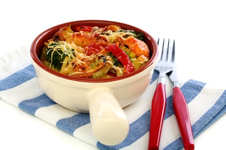 Casserole of pasta, vegetables and cheese in a porcelain pan の写真素材