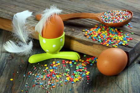 Easter decorations for cakes and eggs on a wooden table の写真素材