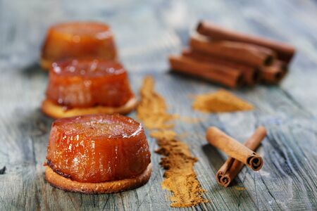 Tarte Tatin with apples and cinnamon on a wooden board の写真素材