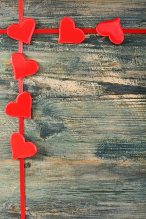 Garland of red hearts on a wooden wall の写真素材