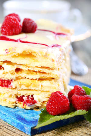 Cake of puff pastry raspberries on the blue board.の写真素材