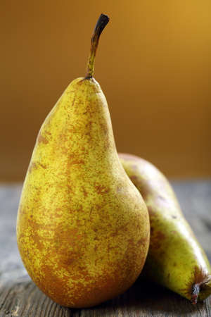 Large ripe pears on old wooden table.の写真素材