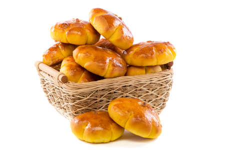 Pumpkin buns in basket on a white background.