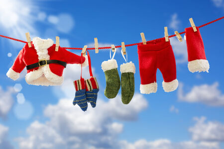 Rope with Santa's clothes over blue sky backgroundの写真素材