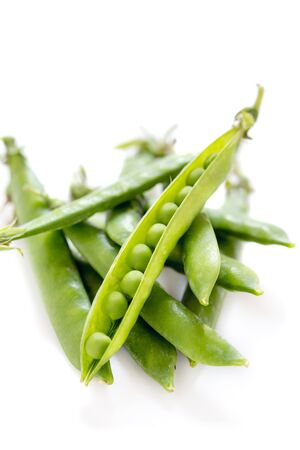 Pods of green peas close-up on a white background.の写真素材