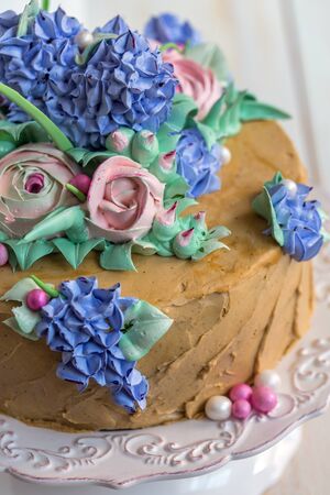 Dish with festive coffee cake on a white wooden table.
