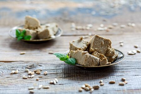 Plates with oriental halva dessert on an old wooden table.の写真素材