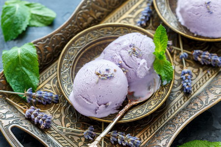Plate with homemade lavender ice cream on a bronze tray, selective focus.の写真素材