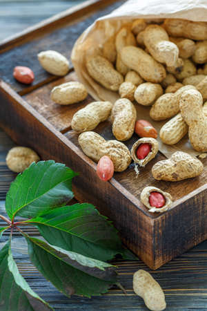 Dry peanuts in the shell on an old wooden box.
