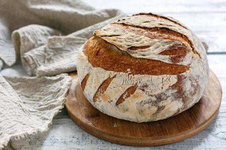 Vermont homemade bread on a wooden table with linen cloth, selective focus.