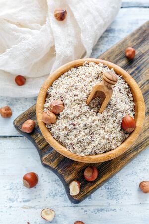 Bowl with hazelnut flour on an old white wooden table.の写真素材