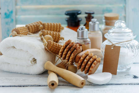 Roller massagers, towel and massage oil on white wooden table, selective focus.の写真素材
