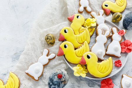 Plate with homemade Easter cookies on a white stone table.の写真素材