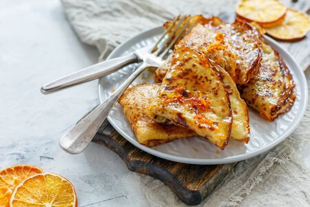 Crepe Suzette with orange sauce for a delicious breakfast, selective focus.