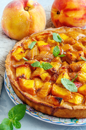 Traditional Italian pie with fresh peaches close-up.の写真素材