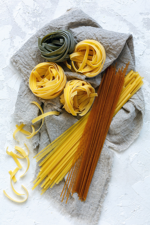 Traditional Italian pasta made of durum wheat on linen cloth. Top view.の写真素材