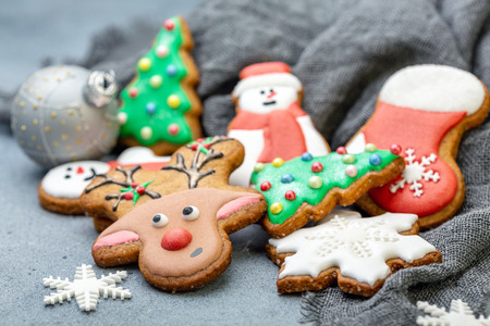 Homemade gingerbread cookies with Christmas on a gray textured background, selective focus.の写真素材