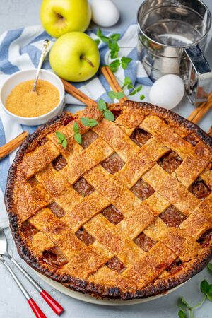 Homemade lattice apple pie with cinnamon on the kitchen table. Top view.の写真素材