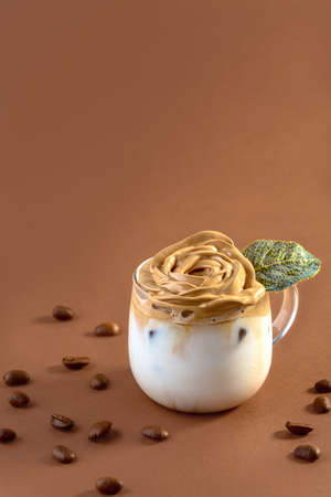 Pearl barley risotto with pumpkin and parmesan in a close up dish with fresh basil. Concept of a...