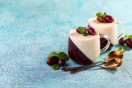 Italian vanilla and berry Panna cotta served in glass cups, selective focus.Traditional Italian dessert.の写真素材