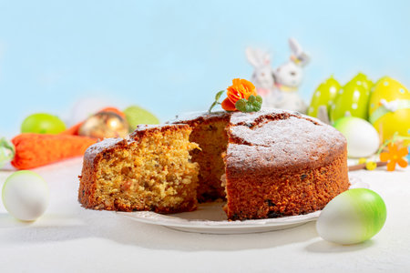 Traditional carrot cake decorated with powdered sugar, carrot flower and mint. Concept of desserts...