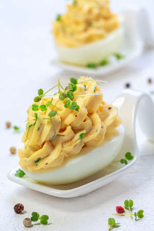 Tender chicken liver in cream sauce with boiled potatoes and microgreens sprouts. Concept of healthy...