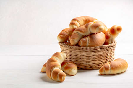 Yeast sweet buns on a baking sheet covered with parchment close-up. Concept of home baking.の写真素材