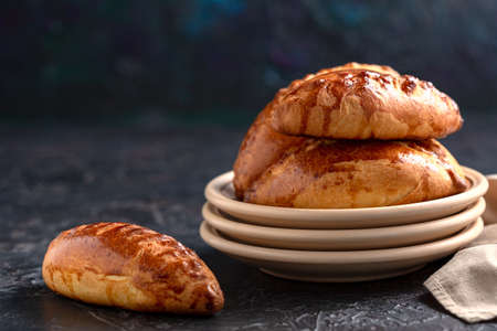 Sourdough bread close-up. Freshly baked round bread with a golden crust on wooden shelf, selective...