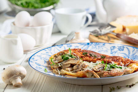 Slicing cauliflower for cooking cabbage steaks with mushrooms, selective focus. Concept of vegetarian cuisine is to eat less meat.の写真素材