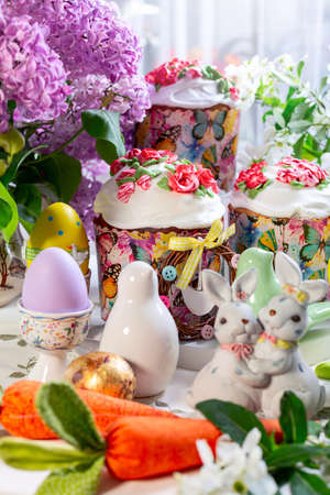Easter composition with orthodox sweet bread, kulich and eggs on light background. Concept of sweet...