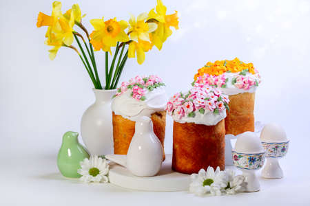 Easter composition with orthodox sweet bread, kulich and eggs on light background. Concept of sweet Easter baking.の写真素材