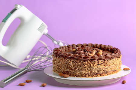 Homemade English cross buns and blooming spring twigs on a wooden serving board. Concept of Easter baking.の写真素材